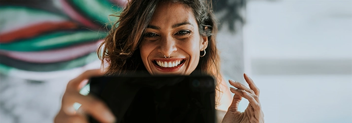 Girl Looking Into Phone Smiling