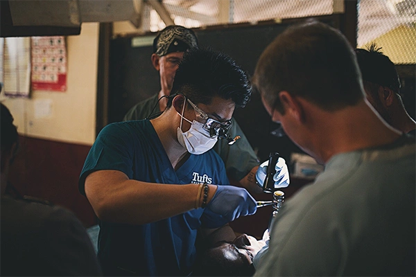 Endodontist Timothy Kim Doing Outreach Work Performing Dental Procedure