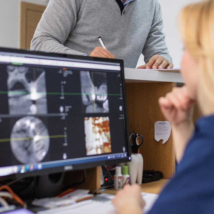 Patient Checking In At Front Desk